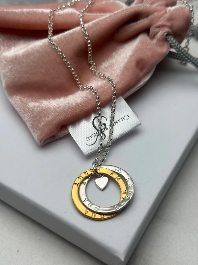 sterling silver chain with intertwined open circle charms in sterling silver and gold plate with silver mini heart charm