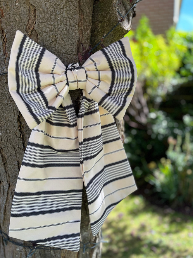 Large decorative bow made with Ian Mankin epire stripe charcoal fabric