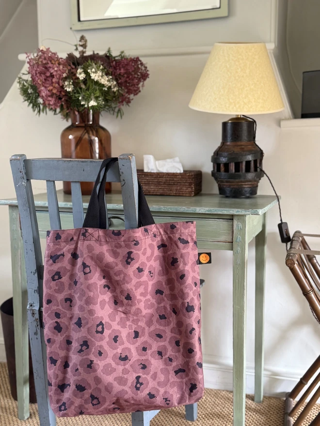 mocha bookbag hanging on chair