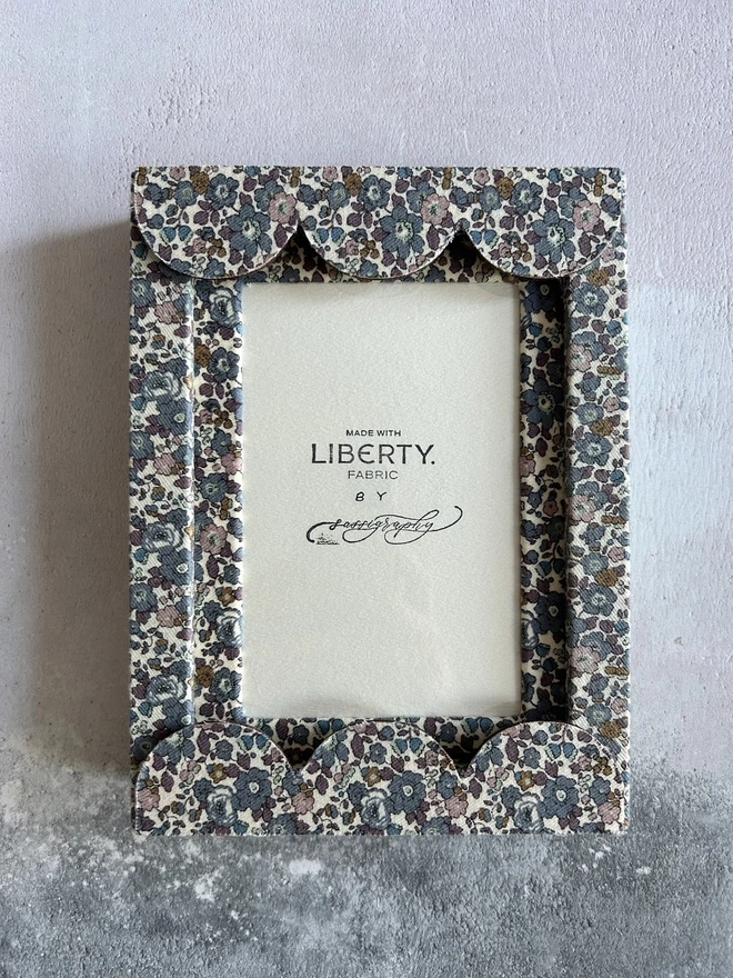 Liberty fabric covered mount frame with scallop edge on flat lay background