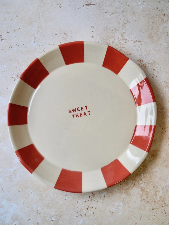 Handmade ceramic plate with red and cream striped rim — “Sweet Treat” text in centre