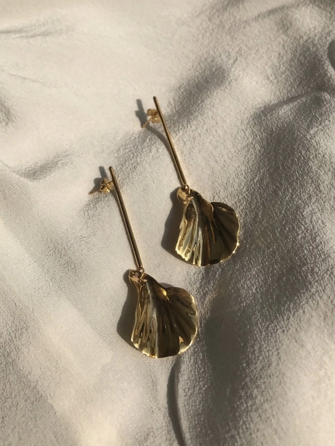 dangly gold petal shaped drop earrings