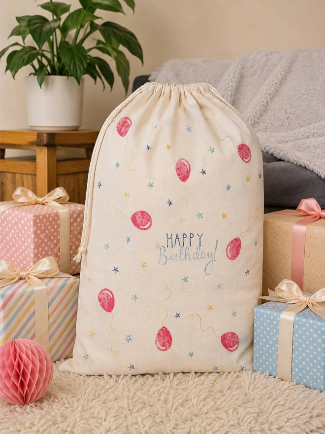 personalised drawstring birthday bag. a drawstring bag with printed balloons and a birthday message.