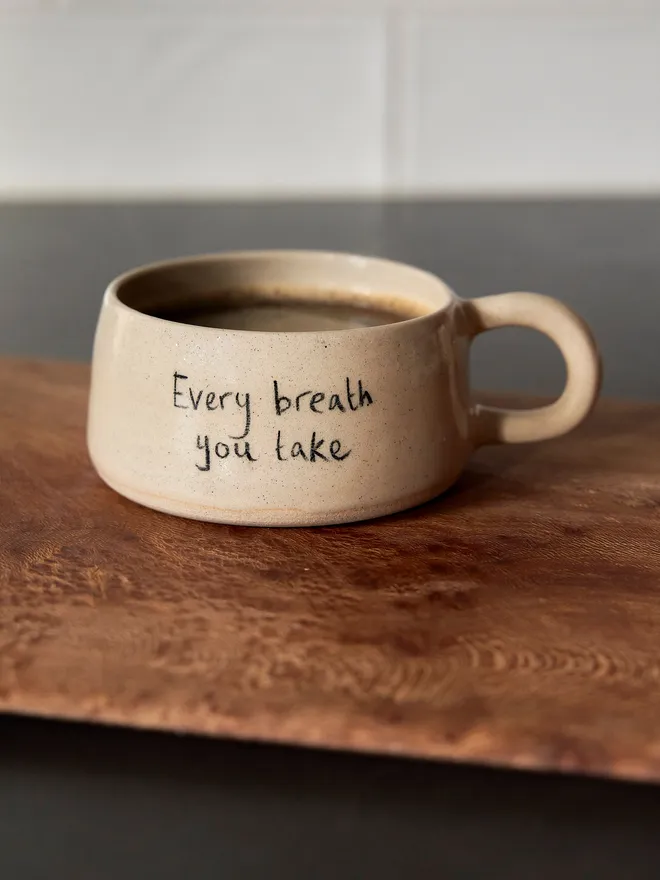 Cream ceramic mug with the words 'Every Breath You Take' written on it 