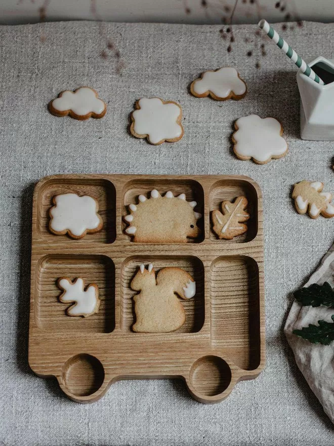 eco wooden london bus tray with forest animal cookies, clouds and leaves