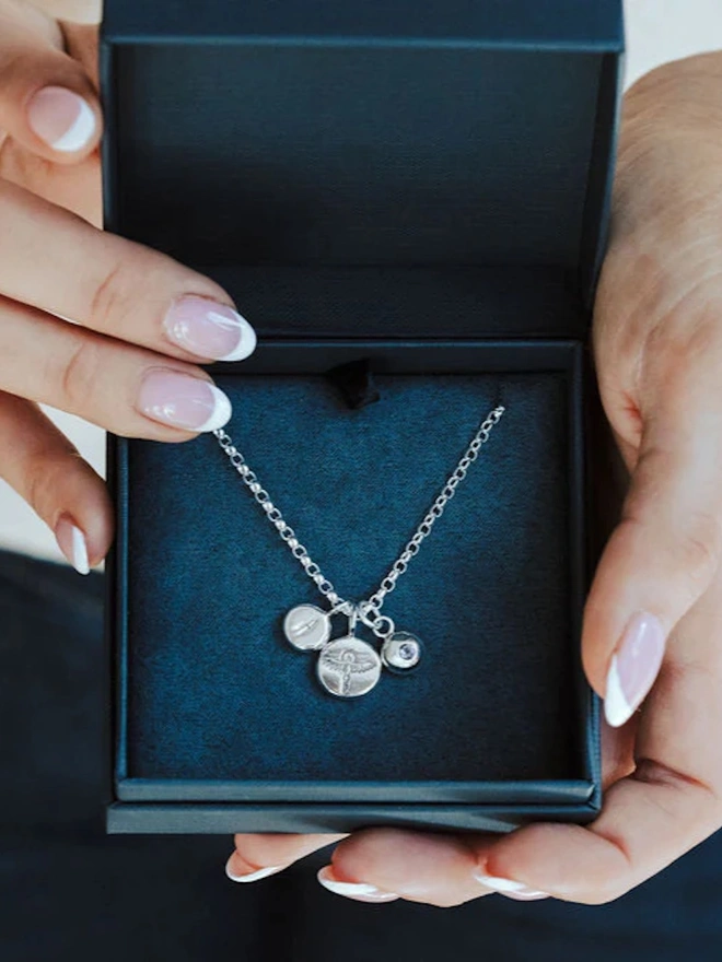 Sterling silver Phoenix Pebble Necklace in a navy blue gift box