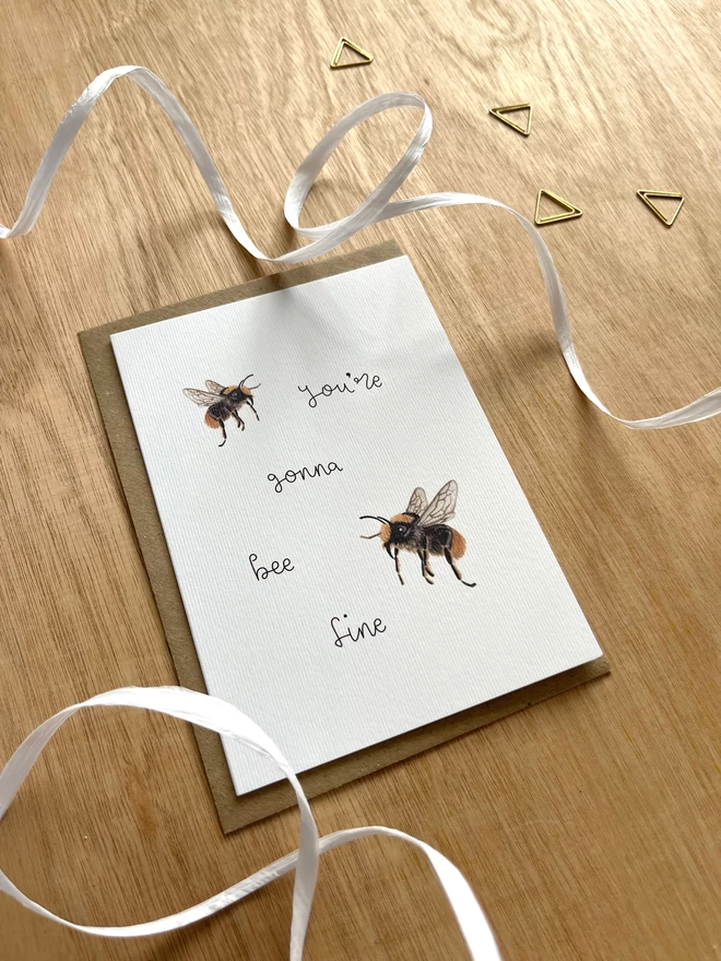 a greetings card featuring a couple of illustrated bees with the phrase “you’re gonna bee fine”