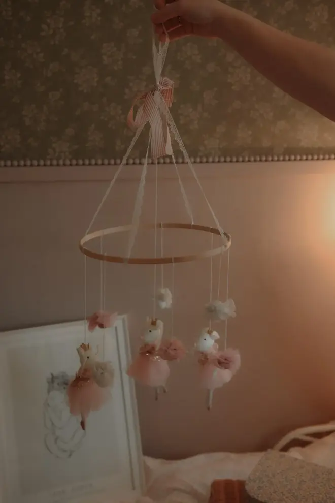 Hanging Mice Ballerina Felt Carousel Decoration, a hanging mice carousel decoration suspended in a child's decorated bedroom. 