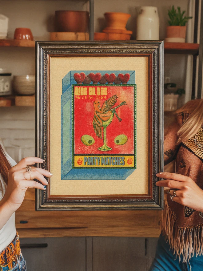 This eye-catching print features a surreal, vintage-inspired matchbox design that blends mid-century commercial art with a gritty, modern "Ride or Die" attitude. Perfect for a home bar, gallery wall, or as a gift for those who appreciate the intersection of high-class leisure and underground aesthetics.  Product Title: "Ride or Die" Vintage Matchbox Art Print The Design This piece captures the grainy, textured feel of mid-20th-century phillumeny (matchbox label collecting). The artwork features a chaotic yet elegant scene: a bird—reminiscent of a peace dove—lounging in a martini glass, flanked by oversized olives and crowned with the bold, rebellious slogan "RIDE OR DIE."  Key Features Unique Aesthetic: A mix of retro pop art and surrealism, utilizing a "risograph" style grain and stippled texture for an authentic vintage feel.  Vibrant Color Palette: Bold reds and sunny yellows contrast against cool blue and green accents, all set on a warm, aged-paper background.  Intricate Details: From the heart-shaped match heads to the "Price Re. 0-04" stamp, every element is designed to evoke nostalgia for old-world advertising.