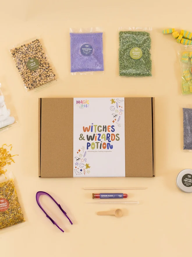 witches and wizards themed childrens potion kit. nine bags of different sensory materials packed into bags and placed around a cardboard box.