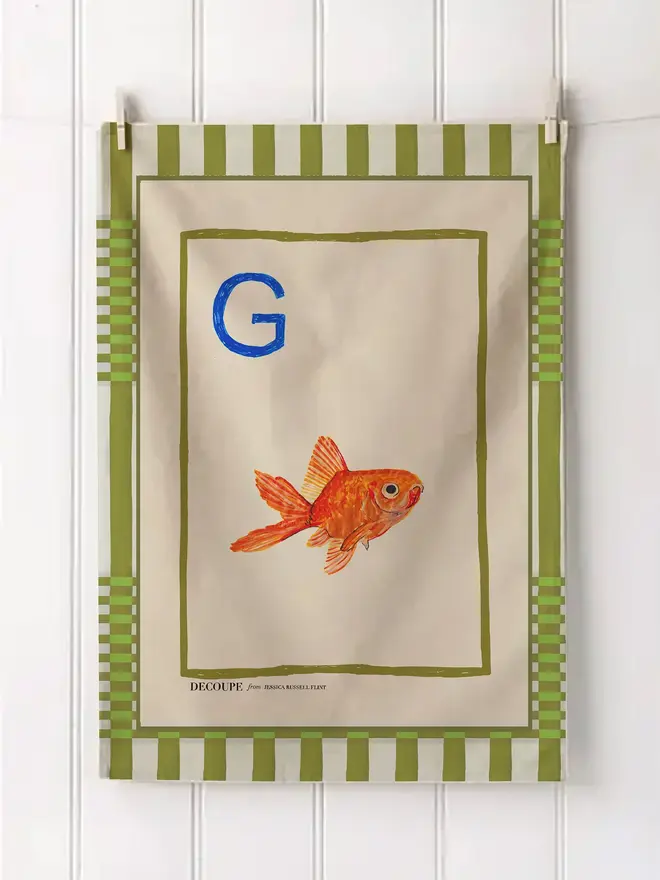 a-z alphabet tea towel. a tea towel with a goldfish print and the letter 'g' in the corner.