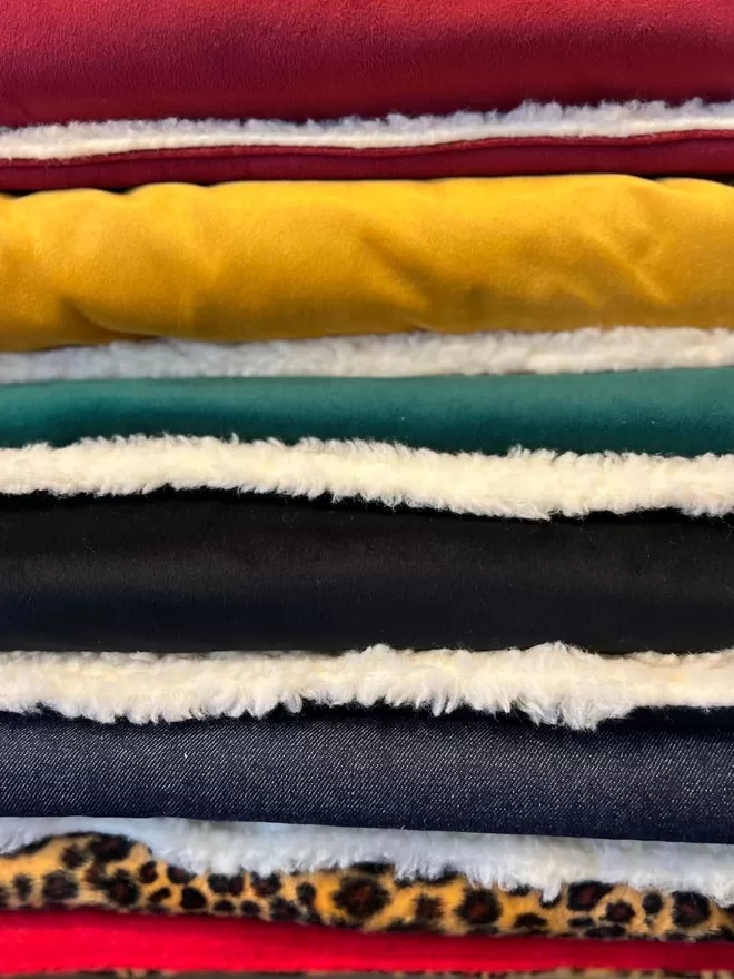 Pile of Padded Blankets in Velvet and Sherpa
