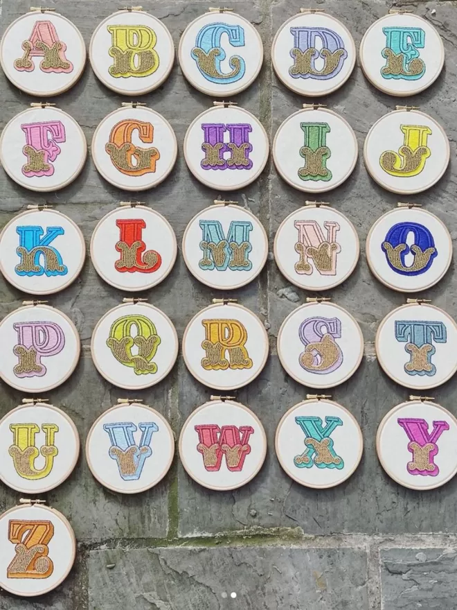 An alphabet of finished embroidery hoops