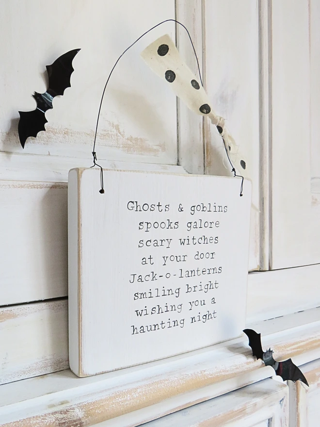 hand painted wooden sign with ghosts and goblins rhyme and spotty ribbon detail