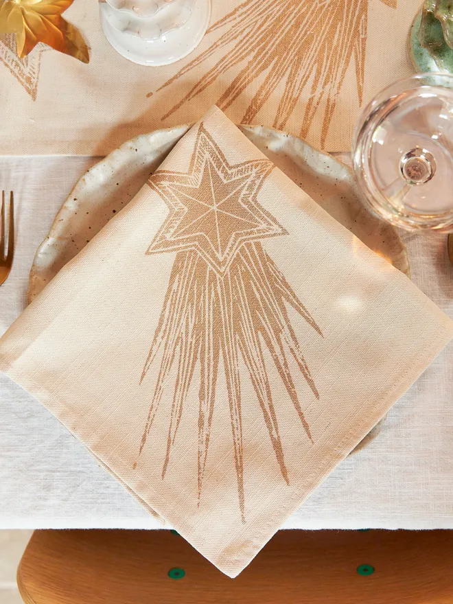 Gold star napkin in a christmas set up 