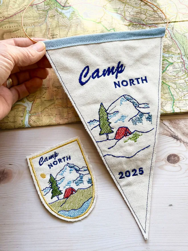 Embroidered mini camp pennant flag with a matching patch on a vintage map