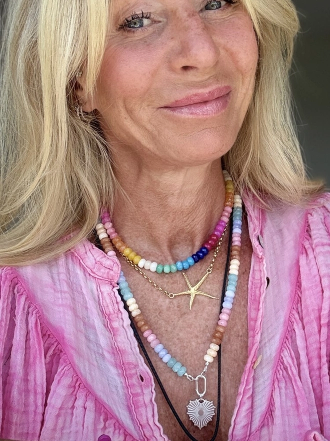 Gemstone beaded necklace. A multi-coloured gemstone jade necklace shown stacked with other gemstone necklaces