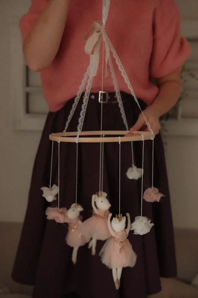 Hanging Mice Ballerina Felt Carousel Decoration, a hanging mice carousel decoration suspended in a child's decorated bedroom. 