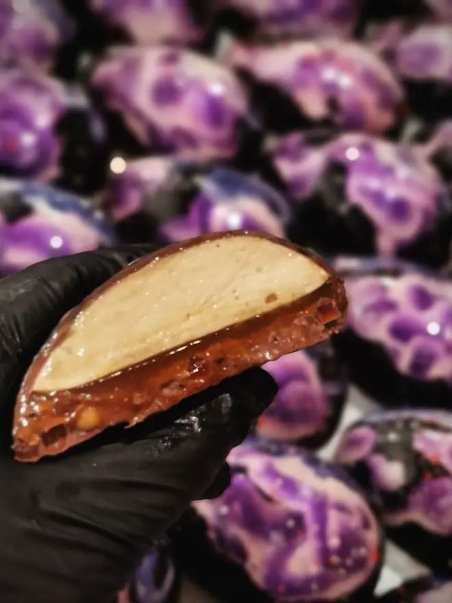 inside of a chocolate easter egg half, showing mascarpone cream and caramel