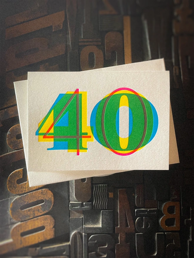 Contemporary handmade letterpress 40th birthday card featuring a bold oversized "50" in a vibrant typographic design. Printed using overlapping cyan, magenta and yellow inks to create striking secondary colours with a deep tactile letterpress impression. Individually hand printed on premium 350gsm GF Smith Colorplan card and paired with a high-quality 135gsm GF Smith Colorplan envelope in a complementary colour. Produced on a beautifully restored 1915 Arab Crown Folio press.