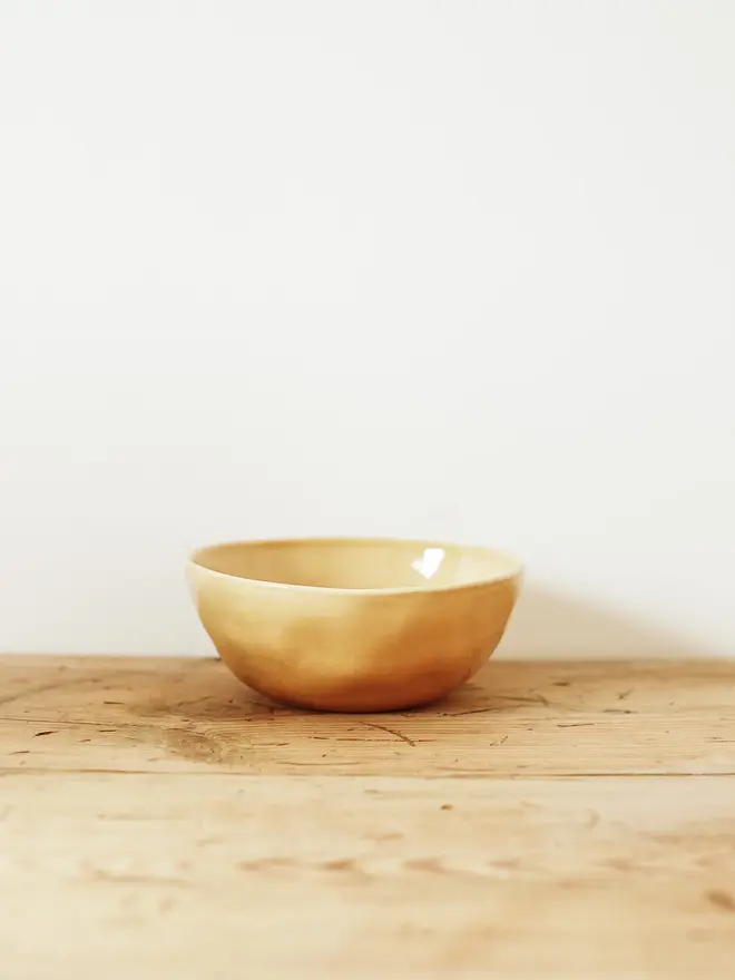 stoneware place setting dining set. a yellow stoneware bowl.