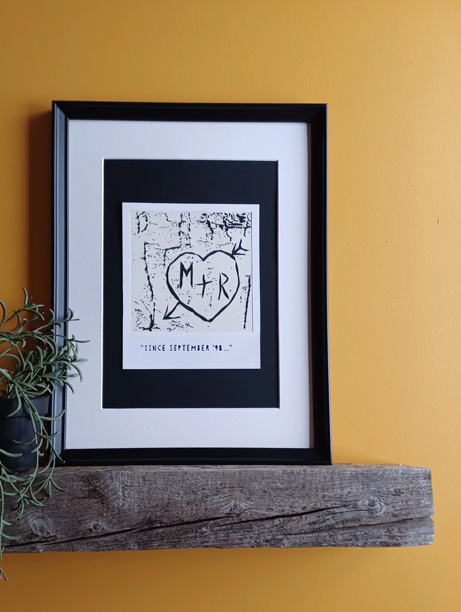 Framed Papercut Showing Initials Surrounded by Love Heart Carved Into Tree Bark