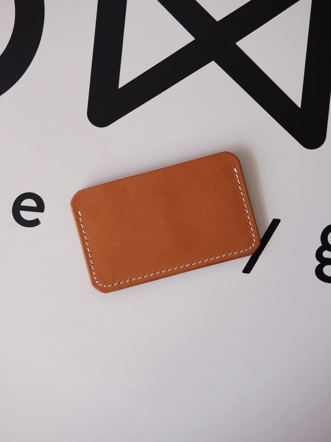 SOWK tan leather card holder seen from the back.