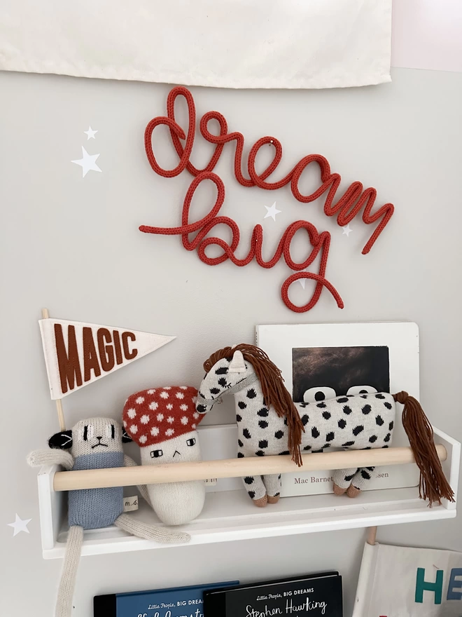 "dream big" inspirational wall art sign hanging in a little one's bedroom. 