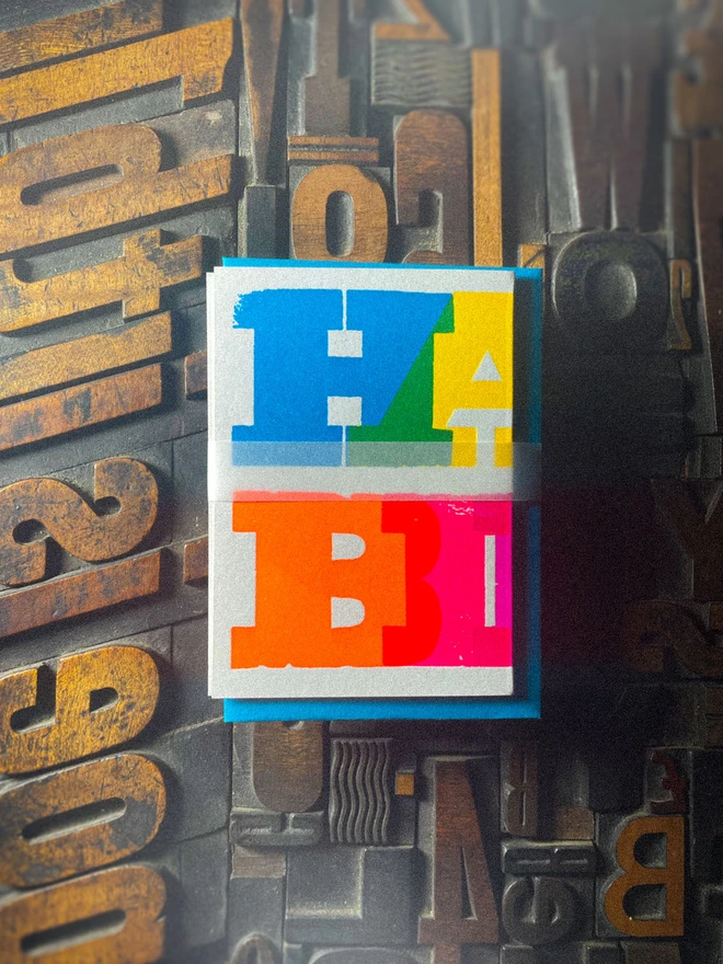 Handmade letterpress concertina birthday card featuring bold, joyful typography in vibrant neon colours. Each card is individually hand printed using traditional letterpress techniques on luxury paper stock, creating a beautifully tactile finish with deep impression and rich ink coverage. The playful fold-out concertina design reveals a striking “Happy Birthday” message across multiple panels, making it both a greeting card and a keepsake.  Created by hand for Holly & Co , this contemporary artisan birthday card combines modern graphic design with traditional craftsmanship. Perfect for design lovers, colourful stationery enthusiasts, and anyone looking for a unique luxury birthday card with personality.