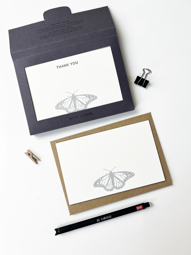 Boxed flat correspondence cards illustrated with a monarch butterfly printed in silver