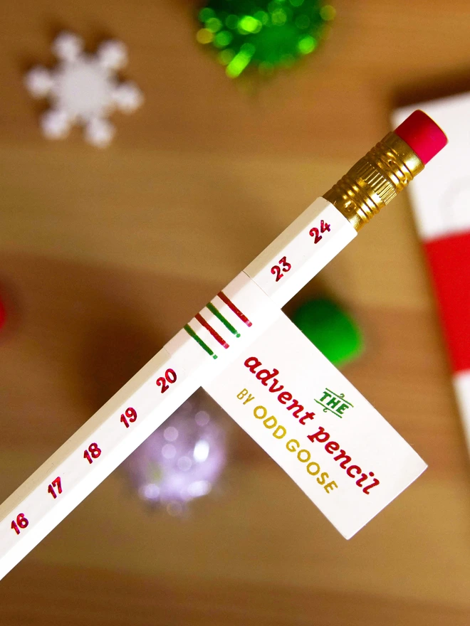 Odd Goose Advent Pencil close up of red foil on white wooden pencil with removable paper tab
