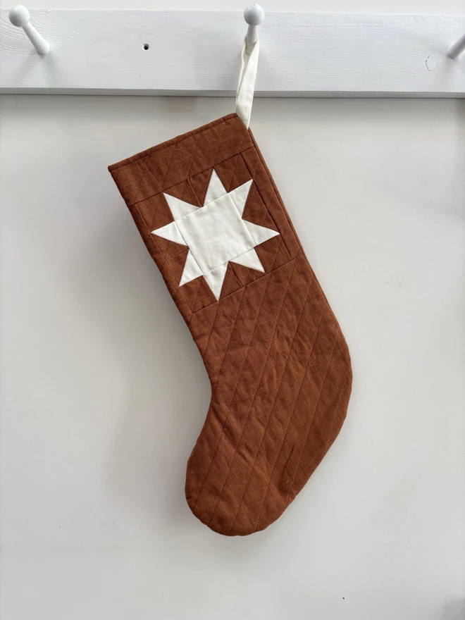 Medium Q  uilted Linen Star Christmas Stocking. Rust linen stocking with ivory linen patchwork star detail.