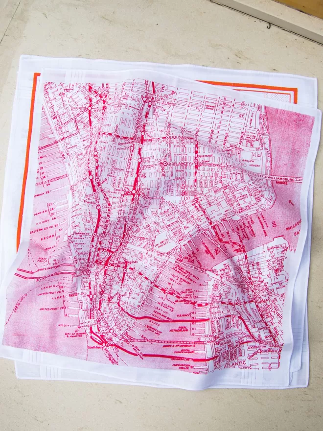 A pile of Mr.PS map handkerchiefs featuring the New York City vintage map hankie in red