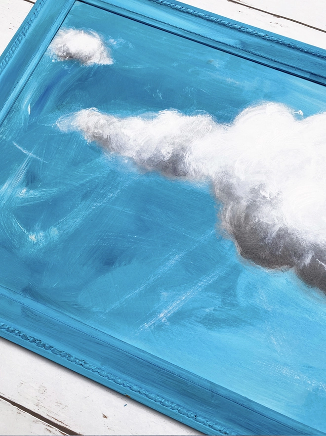 large cloud painting in turquoise painted directly onto a frame