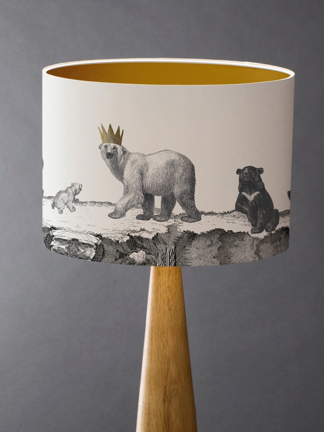 Drum Lampshade featuring bears with a gold inner on a wooden base 