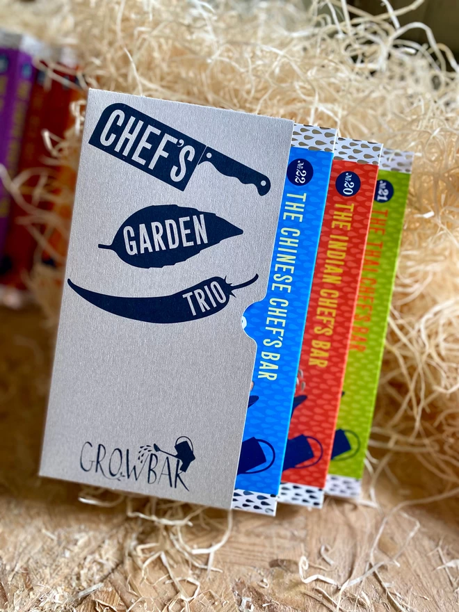 The Chef Garden Trio kit containing a few of the necessary plants to grow Thai, Indian and Chinese flavours nestled on a bed of straw. 