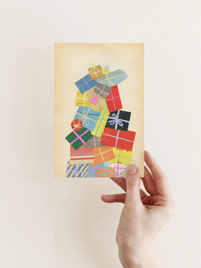 A charming Christmas card featuring a huge pile of colourful wrapped presents.