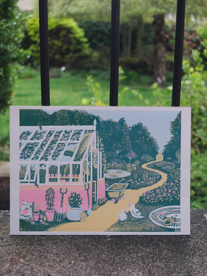 A vibrant print of a garden and greenhouse 