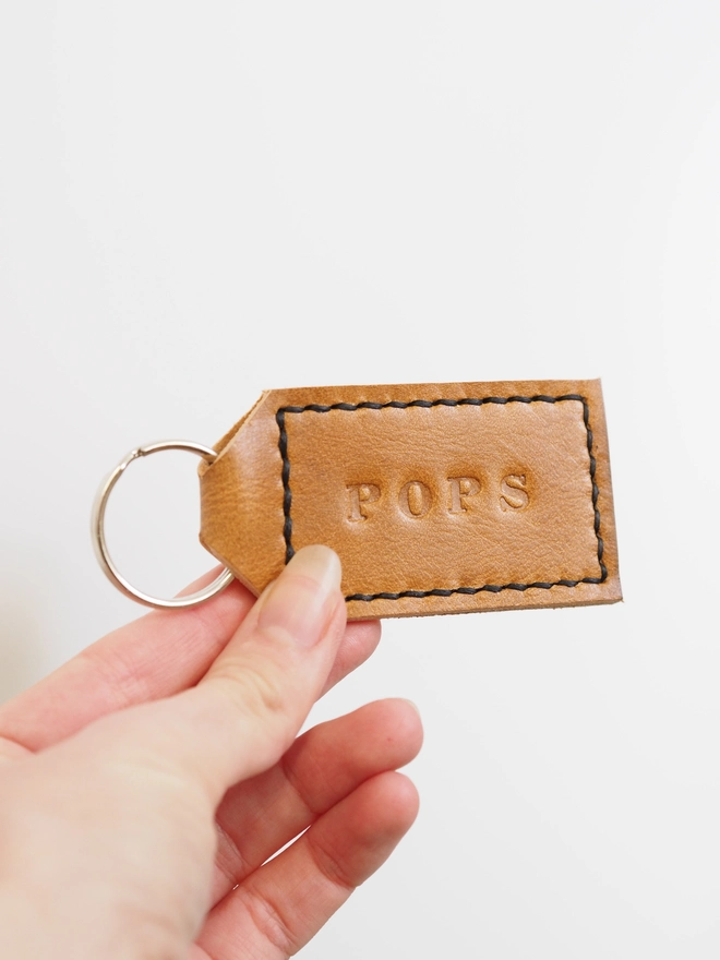 Personalised leather tag shape key ring. Hand stitched with black thread.