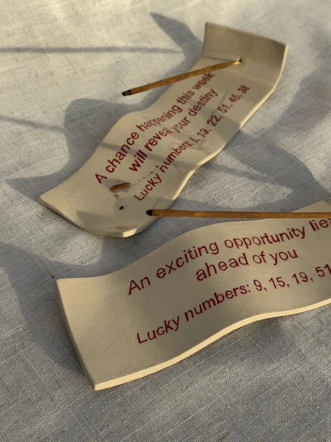 Fortune Incense Holder, a pair of incense holders sitting on a plain white surface. 