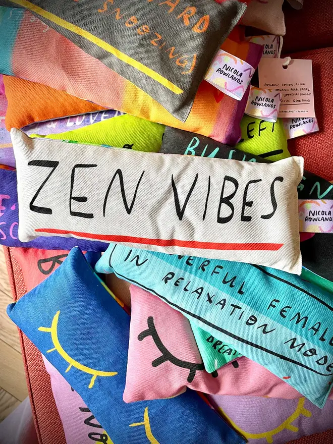 Pile of colourful lavender eye pillows with ZEN VIBES design front and centre