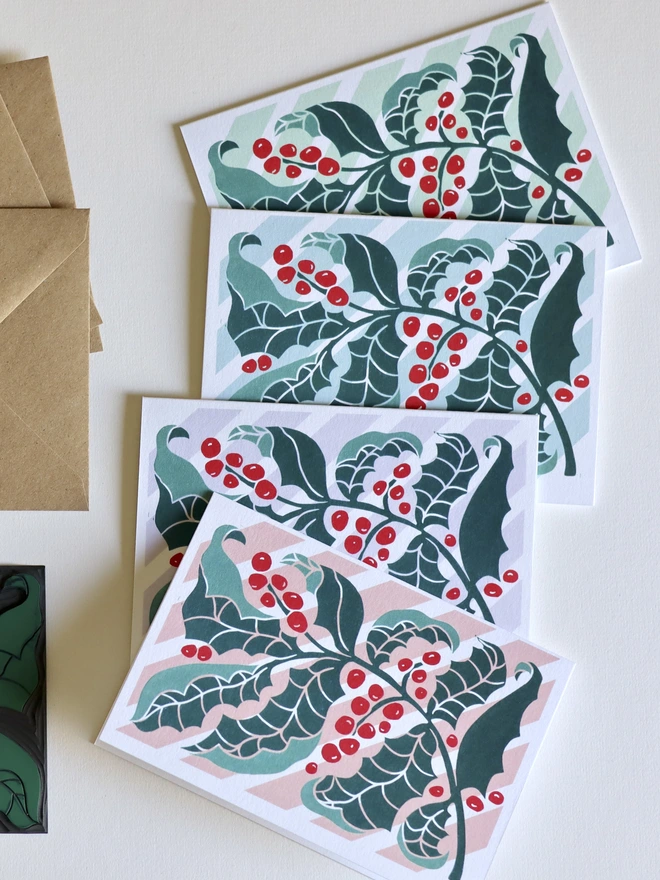 a set of 4 luxury cotton Christmas cards with a modern linocut holly berry design