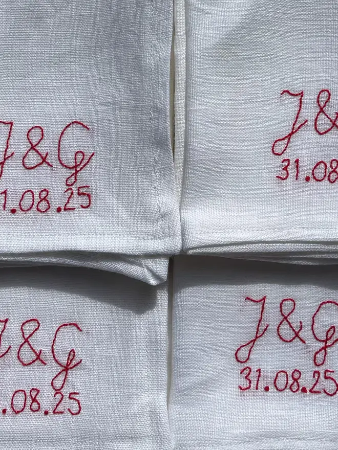 Personalised Hand Embroidered Linen Napkins (Set Of 2), four white napkins with a red personalised message. 