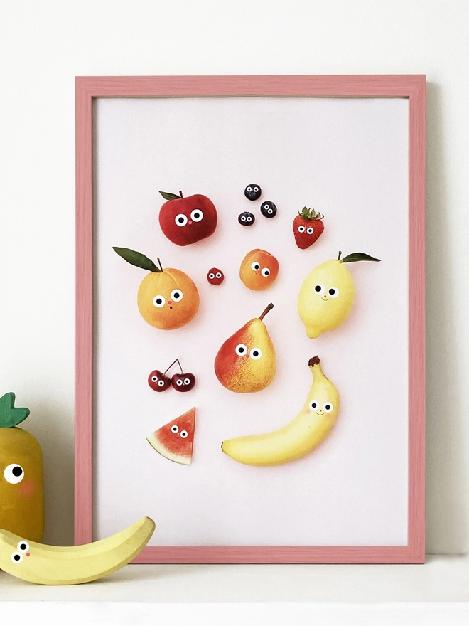 A framed A3 Print with fruit with faces 