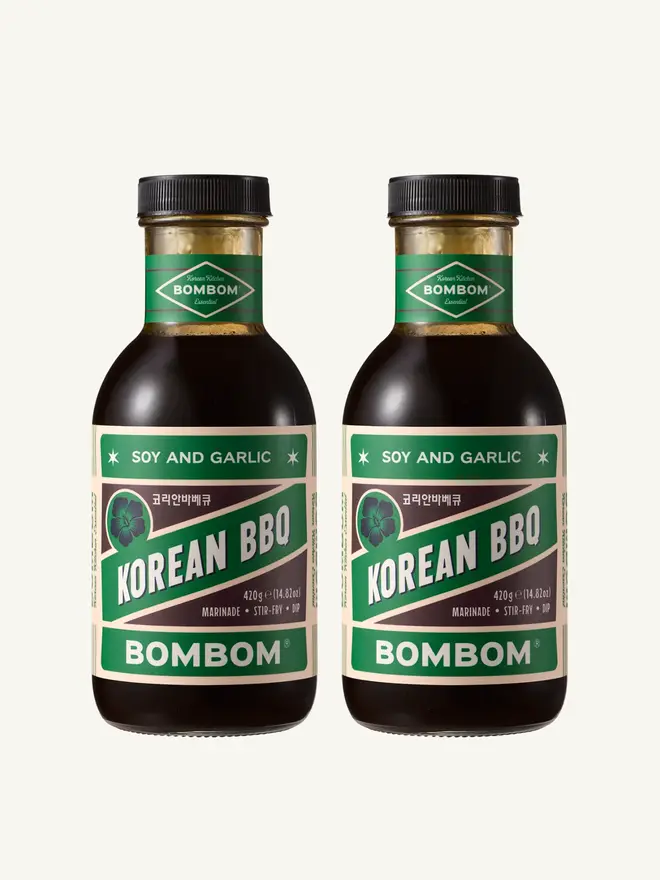 soy and garlic korean bbq sauce. two bottles of bbq sauce with green labels.