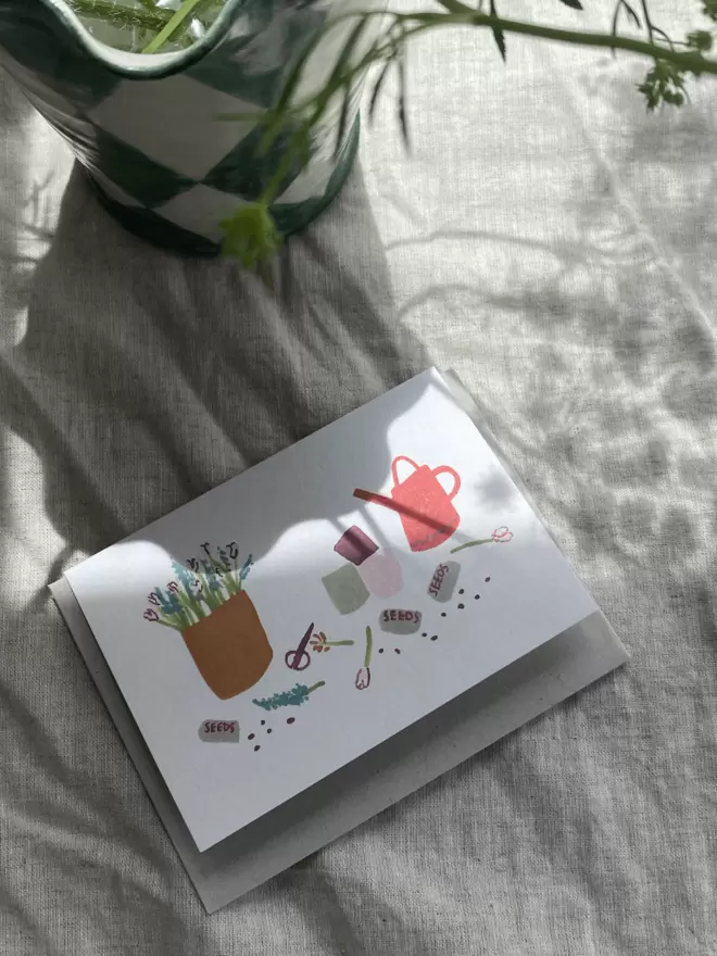 greetings card with watering can, seeds and plants on, perfect for gardeners.
