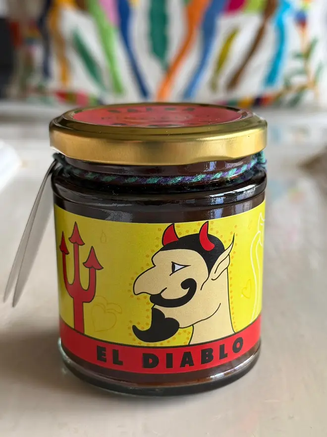 'El Diablo' Salsa Jar (Set Of 1-4 Jars), a salsa jar sitting on a kitchen counter. It has the icon of the devil with a trident. 