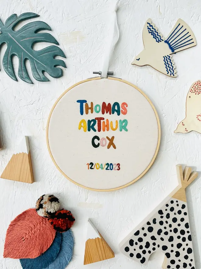 custom embroidered hoop. cotton hoop embroidered with multi coloured lettering.