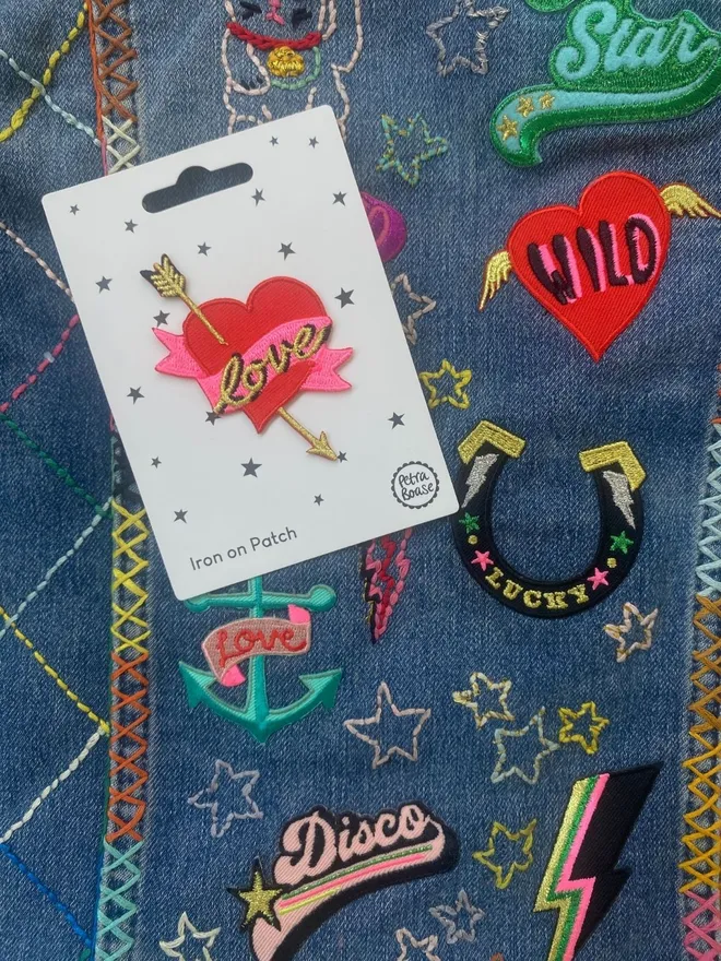 Love heart with arrow on an embroidered kids denim jacket.