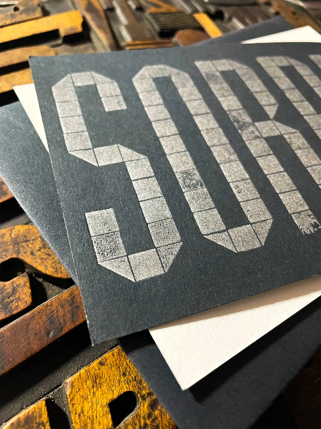 Sorry! A beautiful typographic letterpress postcard printed with metallic silver inks printed on rich thick  colourful card; ideal to send a sympathy note to a friend or loved one.